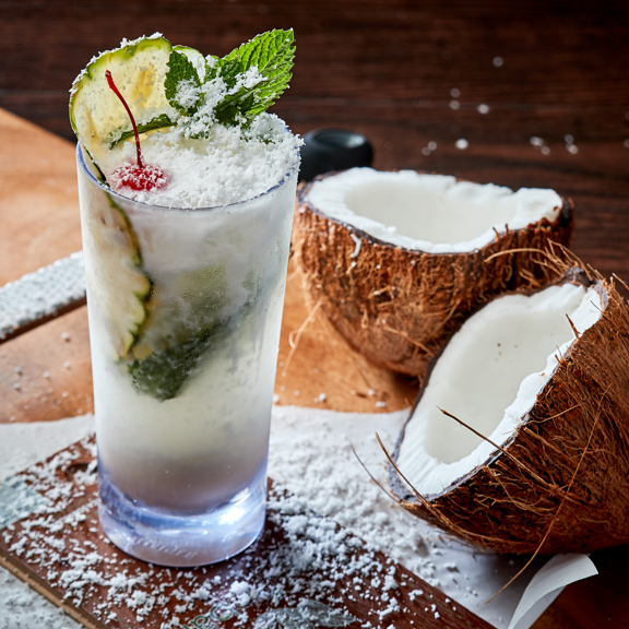 coconut mojito with coconut shavings on table